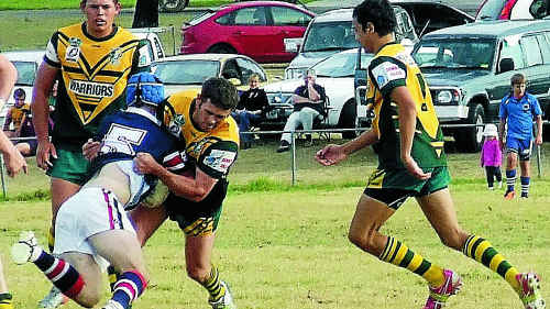 Wattles centre Russell McMillan tackles Cowboys winger Andrew Ryan as Luke Baker and Anthony McIntosh move in to assist in Wattles’ 50 – 20 win over Warwick at Father Ranger Oval. Wattles centre Russell McMillan tackles Cowboys winger Andrew Ryan as Luke Baker and Anthony McIntosh move in to assist in Wattles’ 50 – 20 win over Warwick at Father Ranger Oval.
